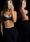 411 Official Core black sports bra with adjustable straps, medium support women's activewear gym bra.