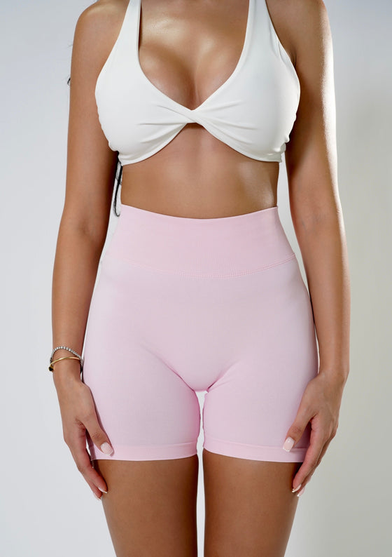 baby pink activewear shorts with a comfortable and stylish design, perfect for workouts and athleisure. Featuring a flattering fit and moisture-wicking fabric for ultimate comfort during exercise